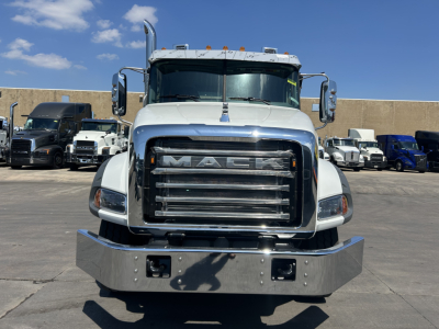 Front view of a new 2026 Mack GR64B roll-off truck showing chrome grille, large bumper, and side mirrors.
