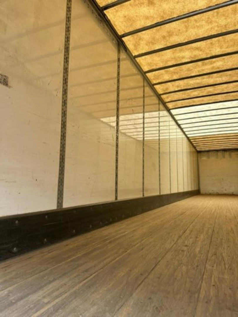 Trailer interior showing wooden floor and side walls of a 2016 Wabash van trailer with empty cargo area.