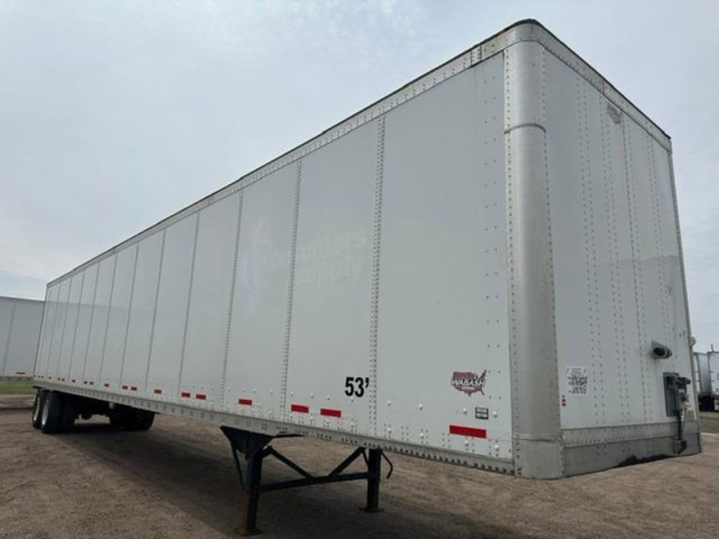 Wabash van trailer showing box-style dry van with 53' length and tie-downs, side and rear doors not visible.
