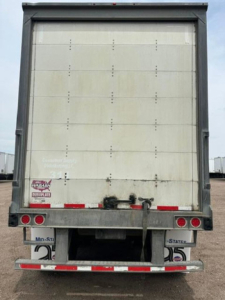 Trailer back of 2016 Wabash van with closed rear doors, bumper, and taillights visible.