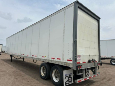 Trailer side view showing a white enclosed van with dual rear axles and U.S. reflectors.