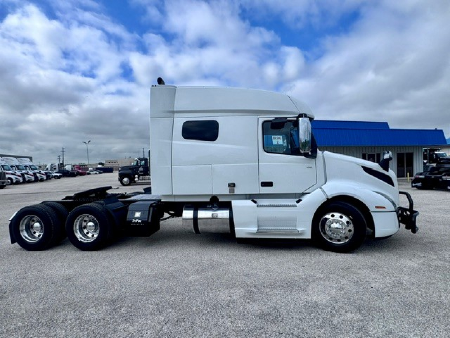 Volvo VNL64T740 tractor truck side profile showing sleeper cab and dual rear axles.