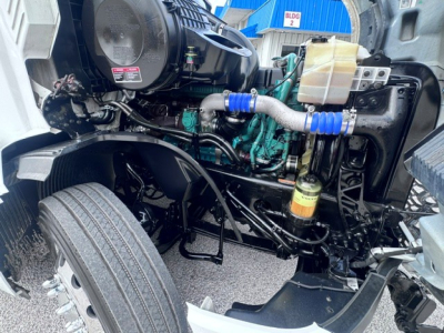 Volvo VNL64T740 engine bay showing VGT engine components, hoses, and coolant reservoir.