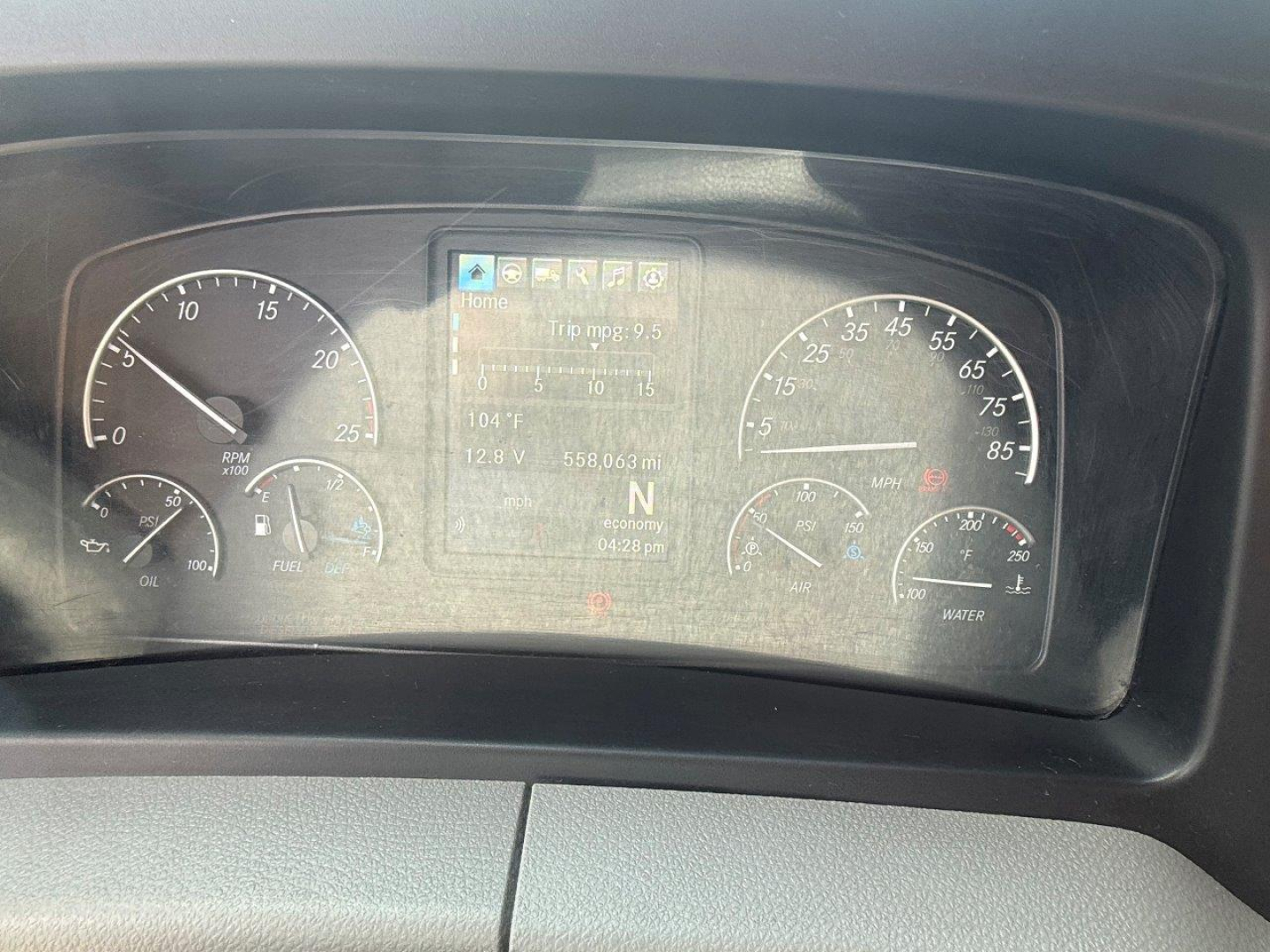 Dashboard cluster of a Freightliner Cascadia 126 showing gauges and digital display. Text visible on display and gauges: VIN, 3AKJHHDRXMSMK7627 on info screen; N (Neutral) indicator; multiple small digits and icons; fuel and coolant gauges