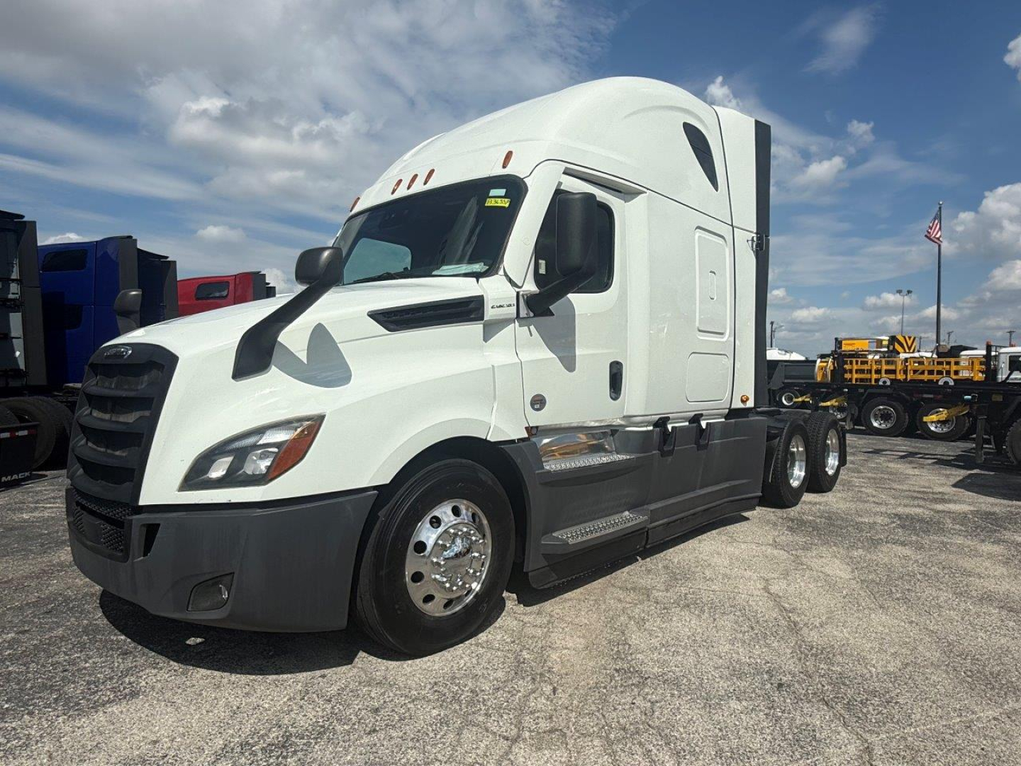 Freightliner Cascadia 126 convention sleeper truck in white with black bumper and chrome wheels, side view showing cab and dual rear axles.