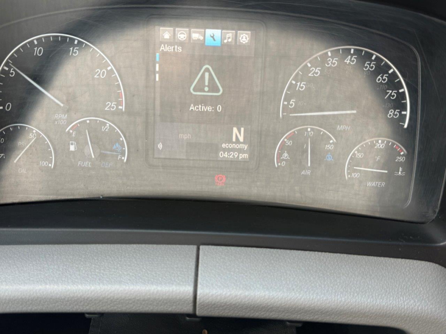 Dashboard of a Freightliner Cascadia showing instrument cluster with speedometer and tachometer, central warning screen displaying a triangle alert and ‘Active: 0’, gear indicator N, ECO mode, and time 04:29 pm.