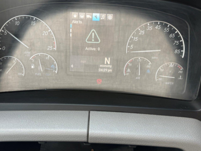 Dashboard of a Freightliner Cascadia showing instrument cluster with speedometer and tachometer, central warning screen displaying a triangle alert and ‘Active: 0’, gear indicator N, ECO mode, and time 04:29 pm.