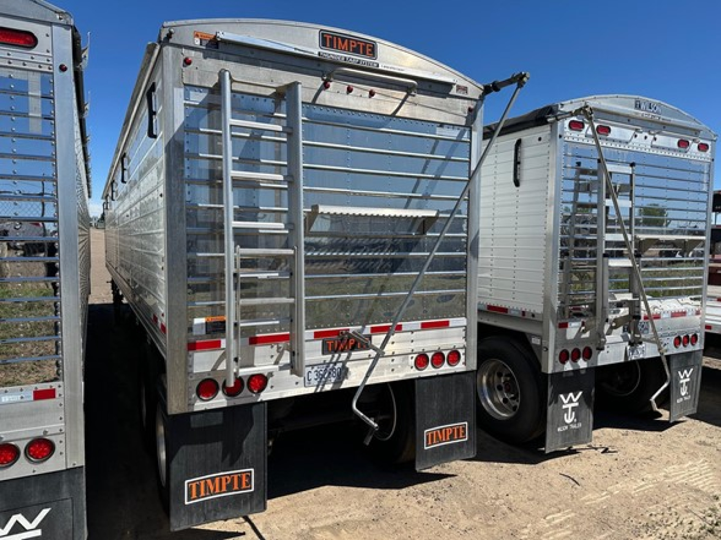 Timpte Super Hopper trailer rear view showing tailgate, ladder, and bumper with Timpte branding and rear lights.