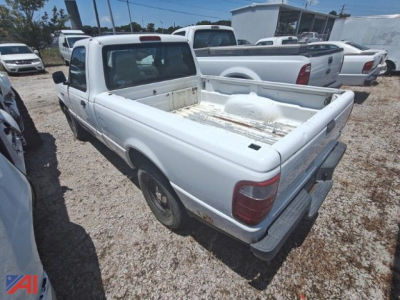 White 2005 Ford Ranger pickup truck with an empty bed, rear three-quarter view, in a used-truck lot.