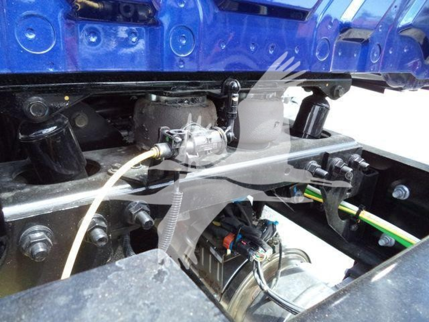 Trucks suspension/drive line area showing fuel line and wiring harness near engine bay in service-ready condition.