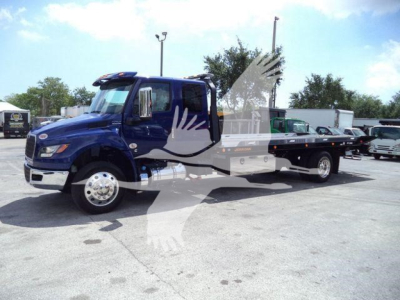 New 2027 International MV rollback truck in blue with flatbed, side view showing cab and chassis.