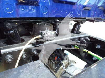 Trucks suspension/drive line area showing fuel line and wiring harness near engine bay in service-ready condition.