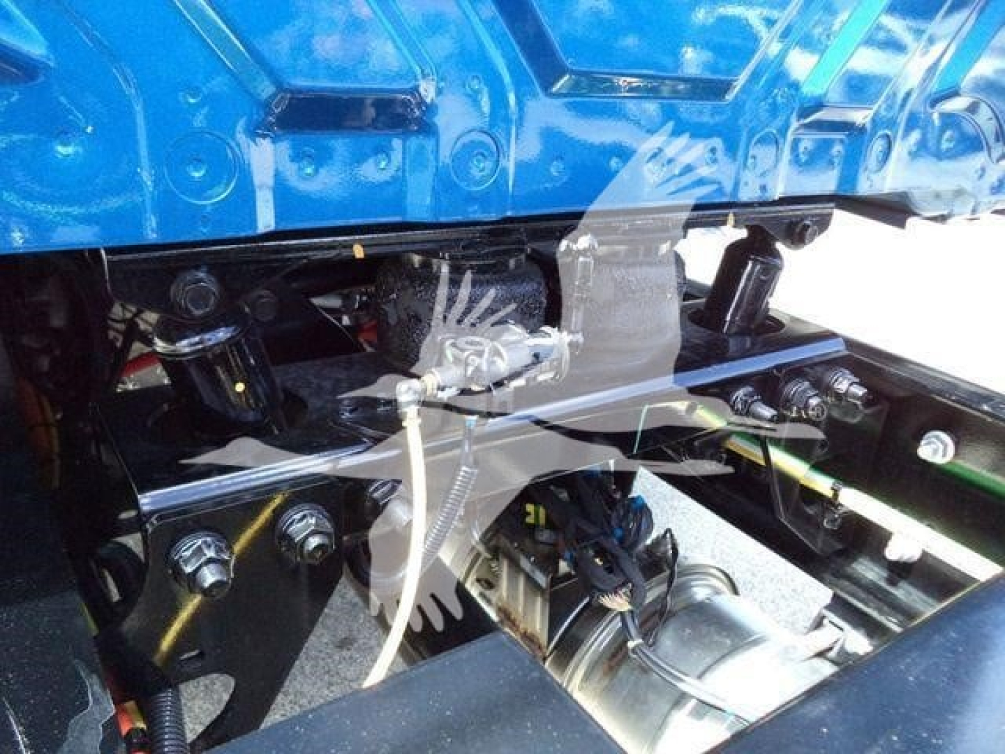 Engine bay of a 2027 International MV rollback truck showing hydraulic lines and components in view.