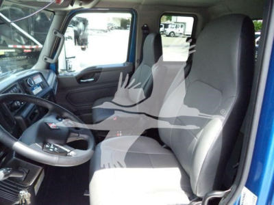 Cab interior of new 2027 International MV rollback truck showing front seats, steering wheel, dashboard, and door panel.