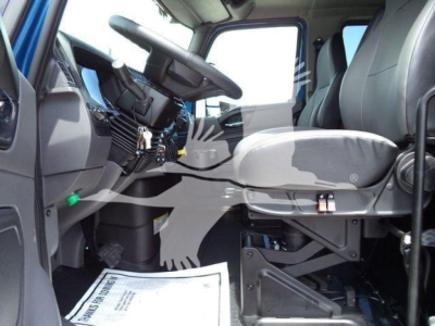 Truck interior view of International MV cab showing driver seat and dashboard area.