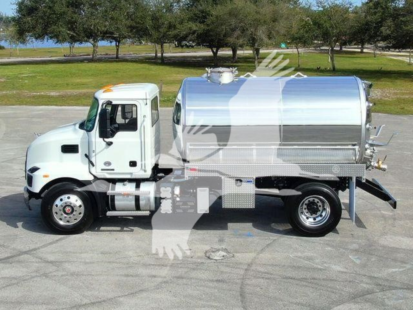 Medium-duty white Mack MD7 sewer rodder truck with a large chrome tanker on a flatbed, side view showing cab, hoses, and rear access.