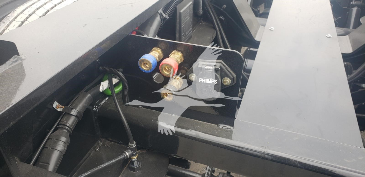 Trailer hydraulic system valves and hydraulic pump with Philips component in engine bay area of Fontaine Magnitude 55Mx lowboy trailer.