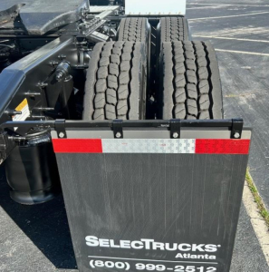 Freightliner Cascadia 113 Evolution chassis with dual rear axles and mudflaps showing SelectTrucks Atlanta sign.