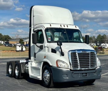 Truck cab showing Freightliner Evolution 113 day cab chassis with chrome grille and white body.