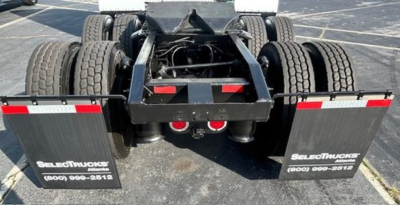 Tractor-trailer rear view showing dual rear axles and mud flaps with SelectTrucks branding.