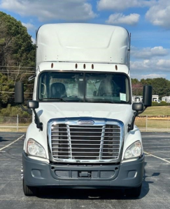 Truck front view of a 2016 Freightliner Cascadia 113 Evolution daytime cab showing large chrome grille and Freightliner emblem.