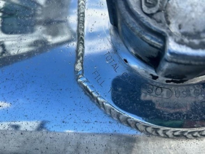 Vehicle fuel cap area on a Freightliner Cascadia showing total fill line and 80 US gal marking.