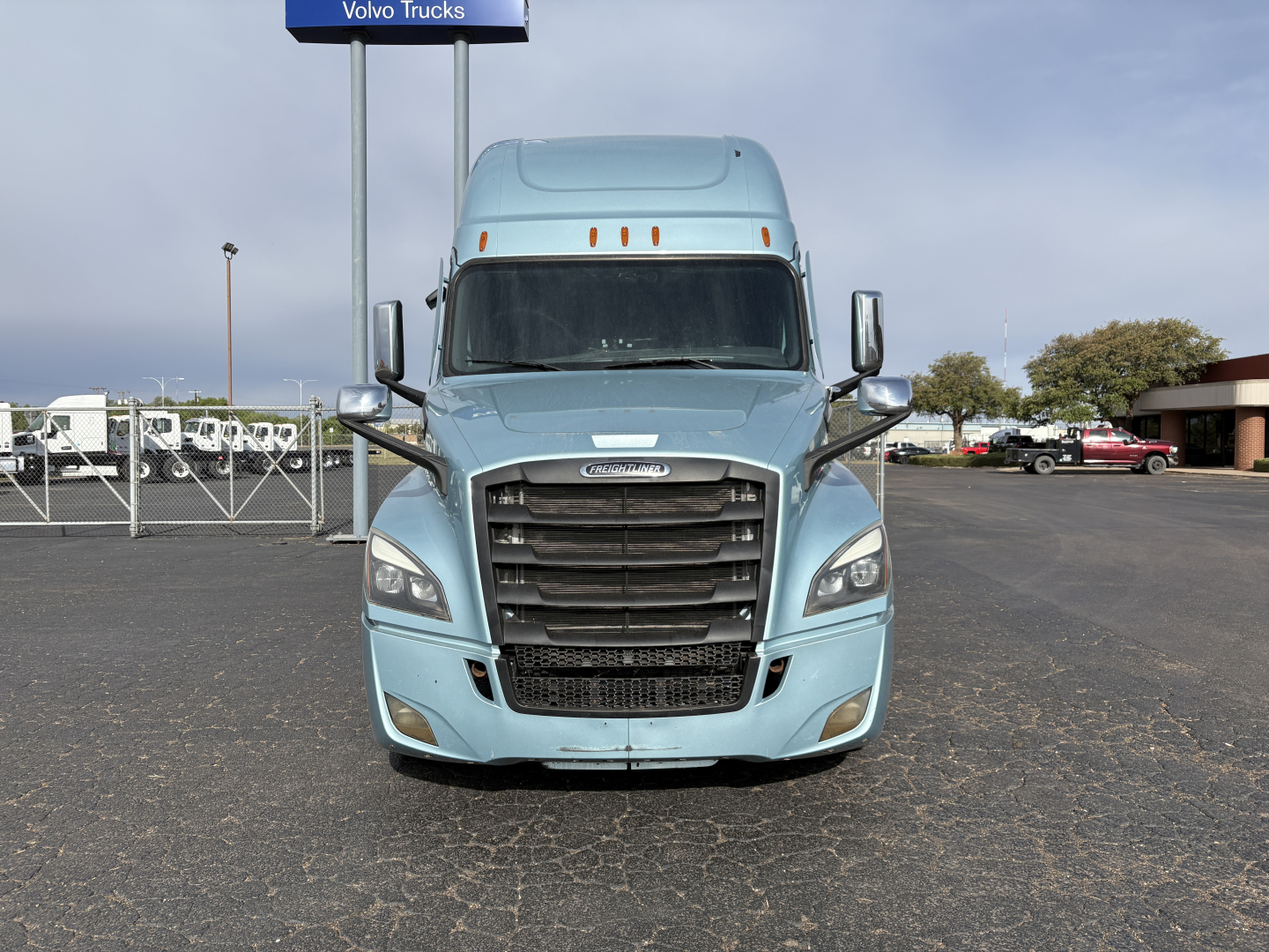 Freightliner Cascadia 126 tractor front view showing blue exterior, grille, headlights, and side mirrors.
