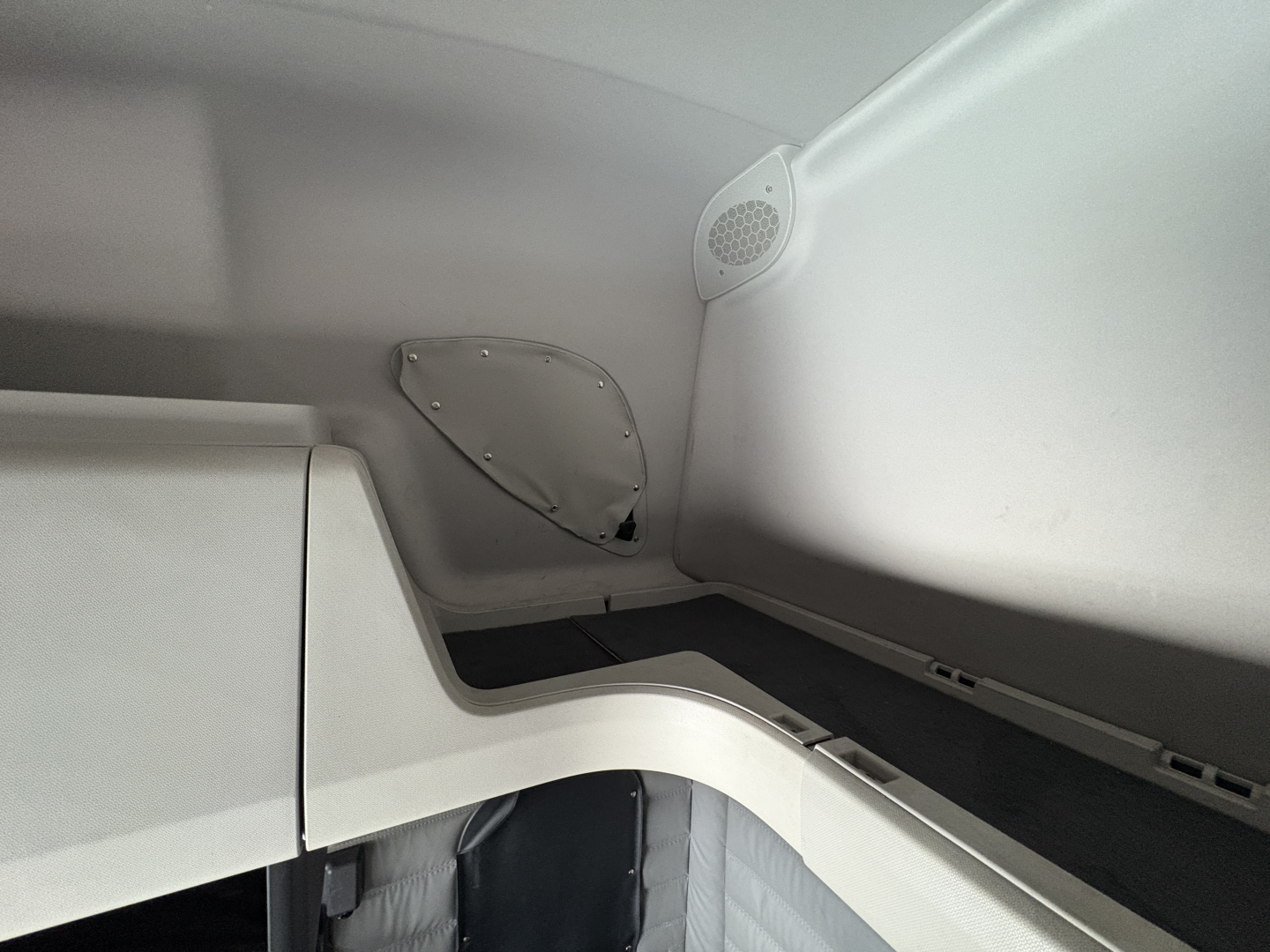 Freightliner Cascadia 126 sleeper cab interior corner showing storage compartments and speaker grill.