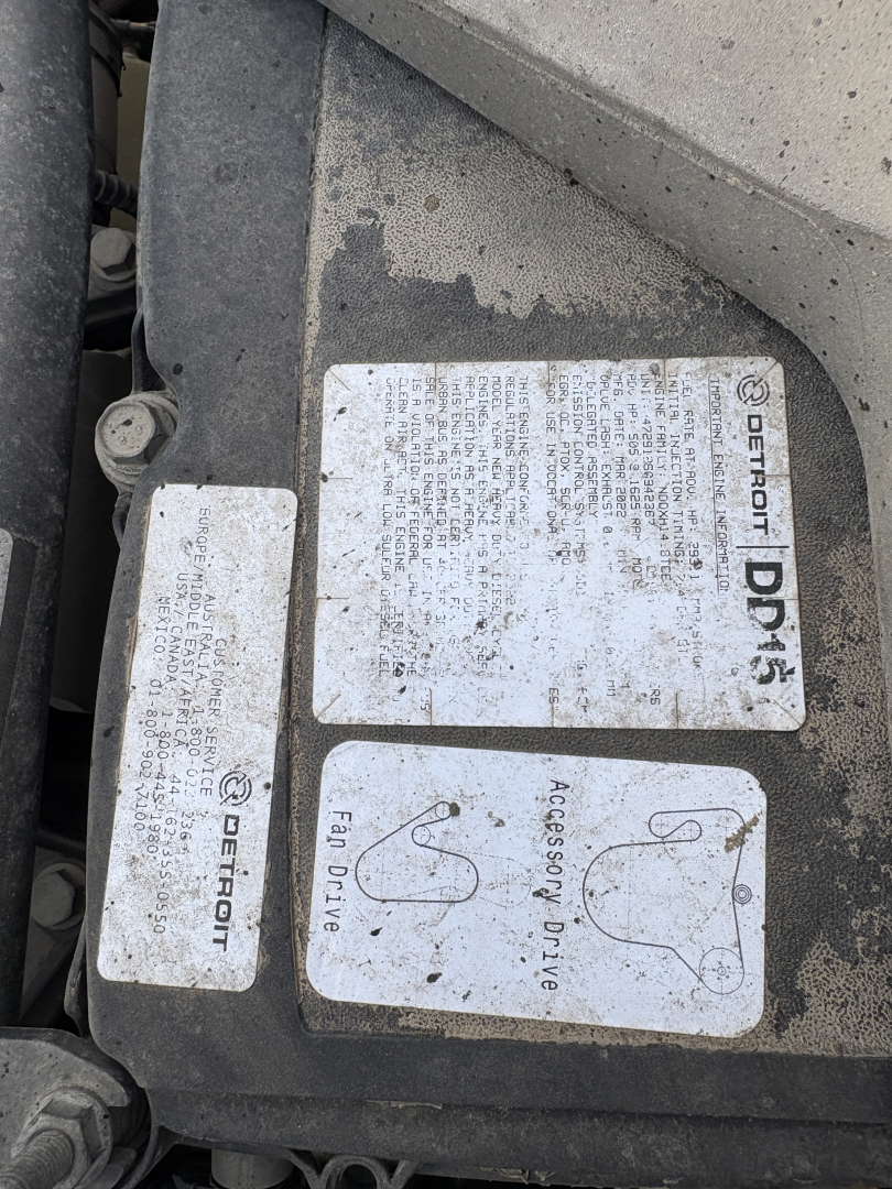 Label cluster on Freightliner Cascadia engine bay showing Detroit Diesel tags and accessory labels with 'Accessory Drive' and 'Fan Drive' text.