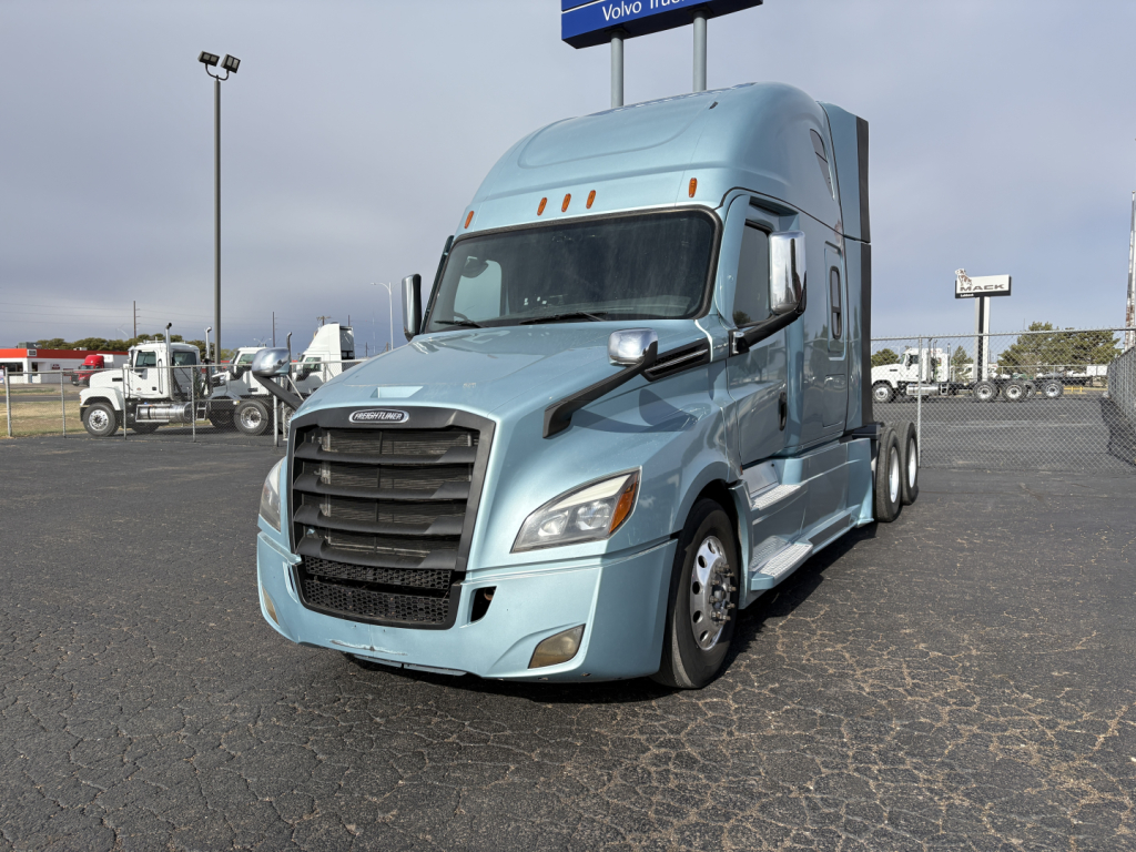 2023 Freightliner Cascadia 126 conventional sleeper truck in light blue, front three-quarter view. Show visible grille, headlights, and side mirrors.