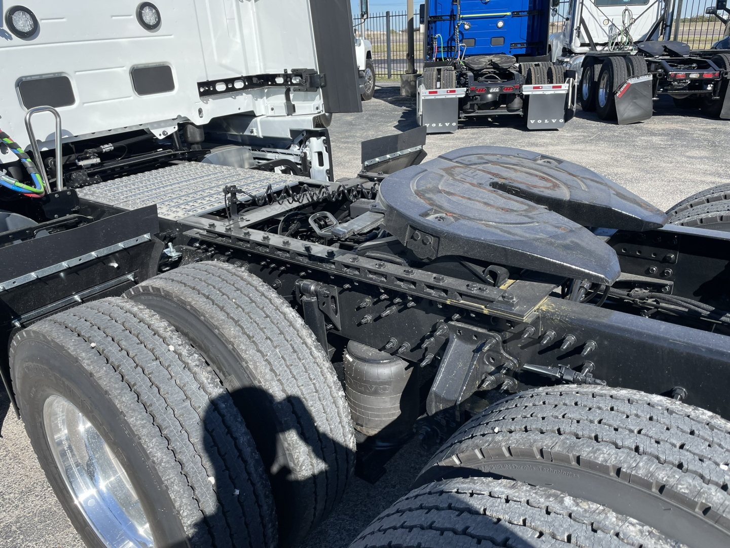Volvo VNL64T860 cab-over semi truck chassis showing twin rear axles and fifth-wheel area.