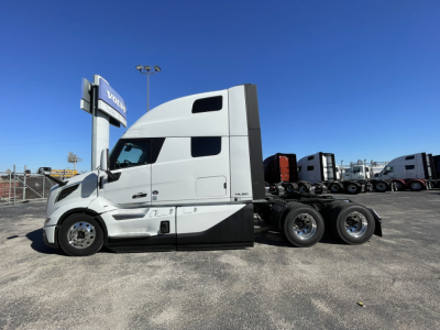Volvo VNL64T860 truck tractor side view showing sleeper cab and 6-wheel rear setup.