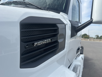 Mack PR64T truck grille close-up showing Pioneer badge on black grille.