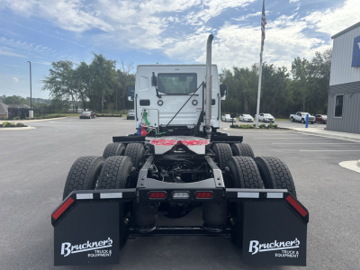 Mack PR64T cab chassis viewed from rear showing dual rear axles and mud flaps with Bruckner's Truck & Equipment branding.