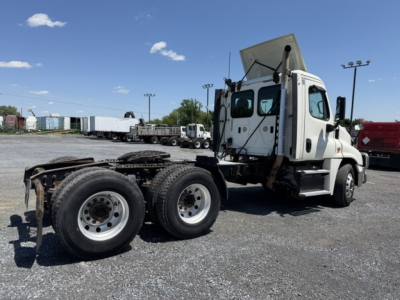 Freightliner Cascadia CA125DC tractor truck rear and side view showing chassis and cab, empty bed, and wheels.
