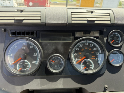 Dashboard of a 2018 Freightliner Cascadia CA125DC showing analog gauges including large left RPM gauge, middle smaller gauges, and right speedometer with various markings.