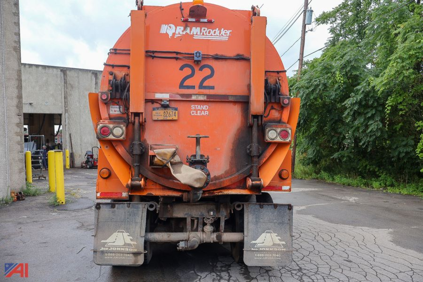 Ford LTS8000 sewer truck rear showing orange body, number 22, RamRoddler sign, and hydraulic components.