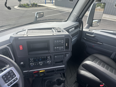 Dashboard and driver area of a new 2026 Mack PR64T. Visible text includes central infotainment/display area, various control buttons, and climate controls. No legible serials or specifications readable aside from vehicle context.