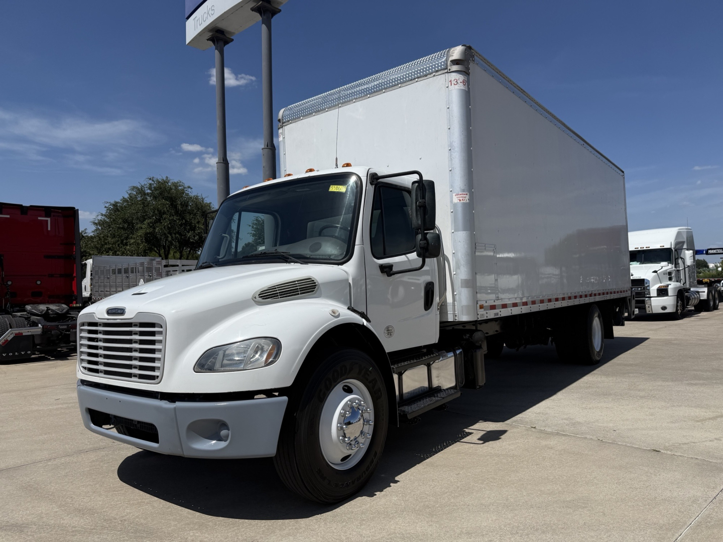 Freightliner M2 box truck in view showing cab and large box cargo area.