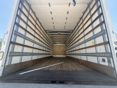 Freightliner M2 truck box interior showing empty cargo area with wooden floor and side rails.