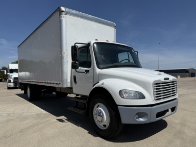 Freightliner M2 box truck in service showing cab and large cargo box.