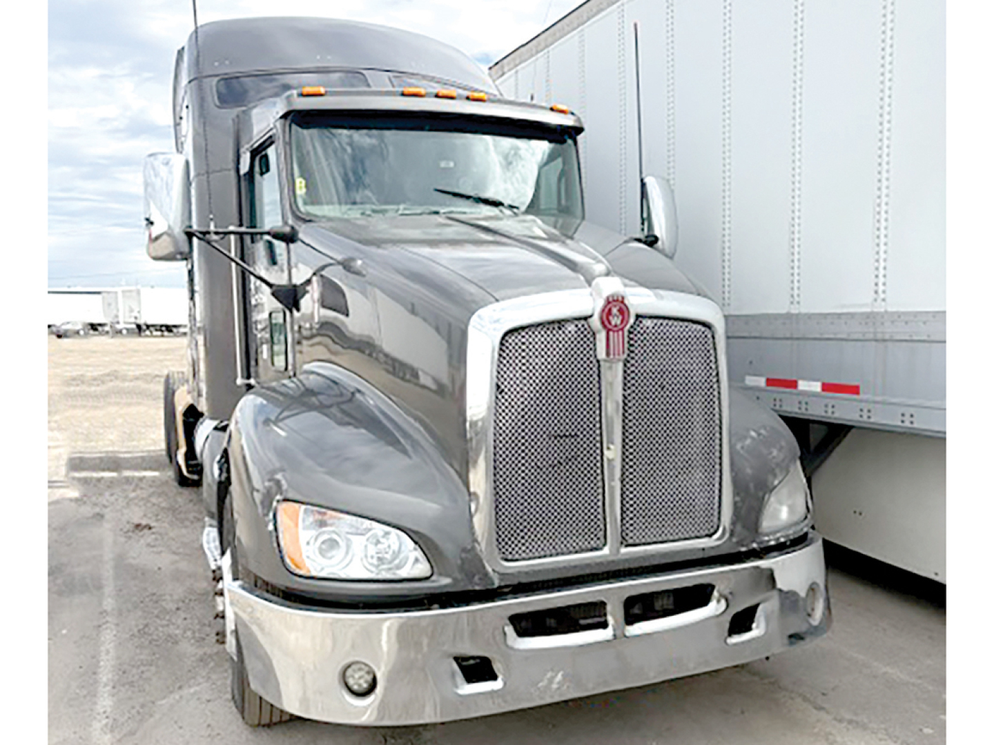 Kenworth T-660 AeroCab truck front view showing chrome grille and headlights.