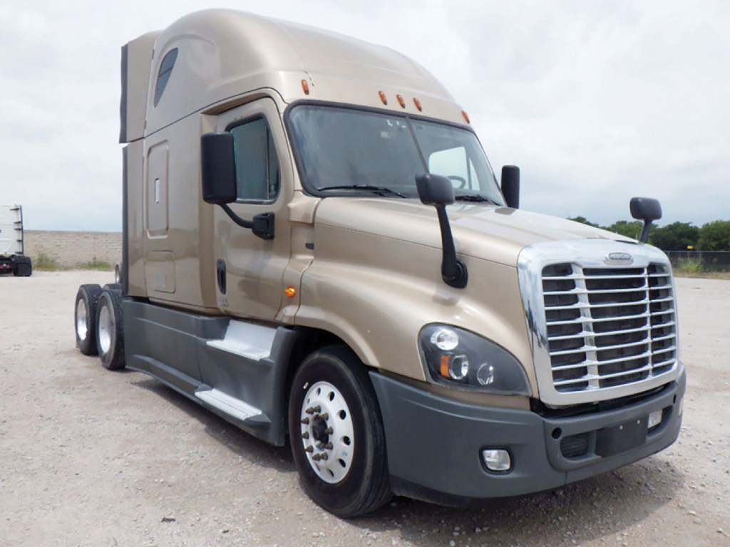 Conventional sleeper tractor in beige with chrome grille, black mirrors, and large cab; Freightliner Cascadia Evolution 2016 on a dirt lot.