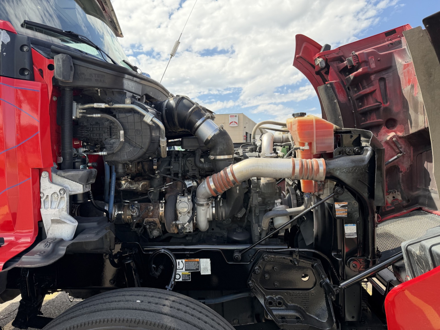 Kenworth T880 truck engine bay with exposed components and hoses