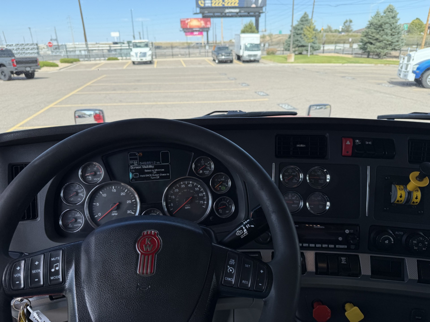 Kenworth T880 truck cab interior with steering wheel and dashboard controls visible