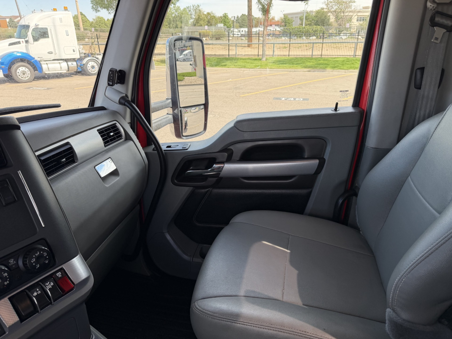 Kenworth T880 truck cab interior showing driver door panel and front bench seat