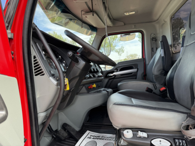 Kenworth T880 truck interior showing driver's seat and steering wheel, dashboard, and center console.