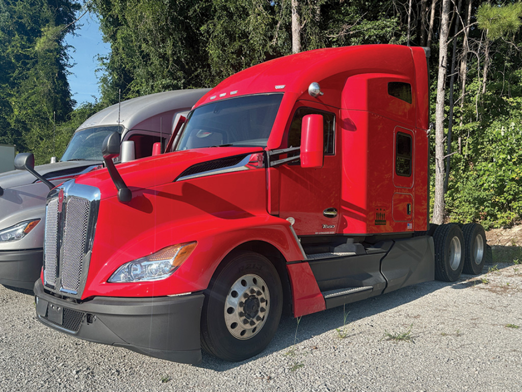 Kenworth T680 Next Gen tractor in red, side view showing cab and front wheels.
