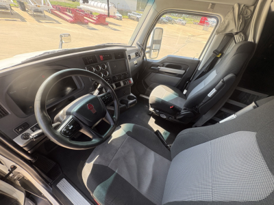 Kenworth T680 cab interior with steering wheel, dashboard, and front seats visible.