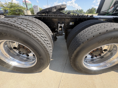 Dual rear truck wheels and chassis of a 2022 Kenworth T680 seen from above showing twin tires and drive axles.